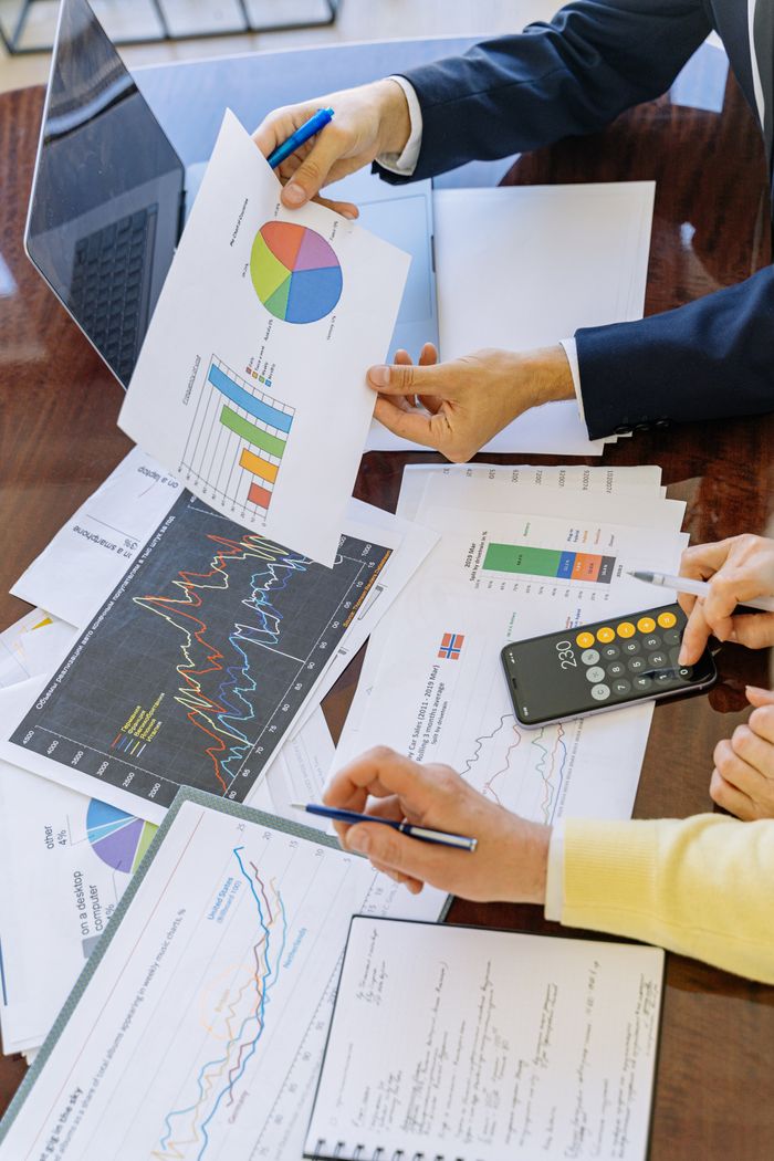 hero-img-01 Business professionals analyzing financial charts and graphs during a meeting.